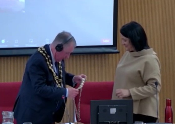 Newly elected Chair Cllr Glyn Haynes presents Vice Chair Non Dafydd with her chain of Office